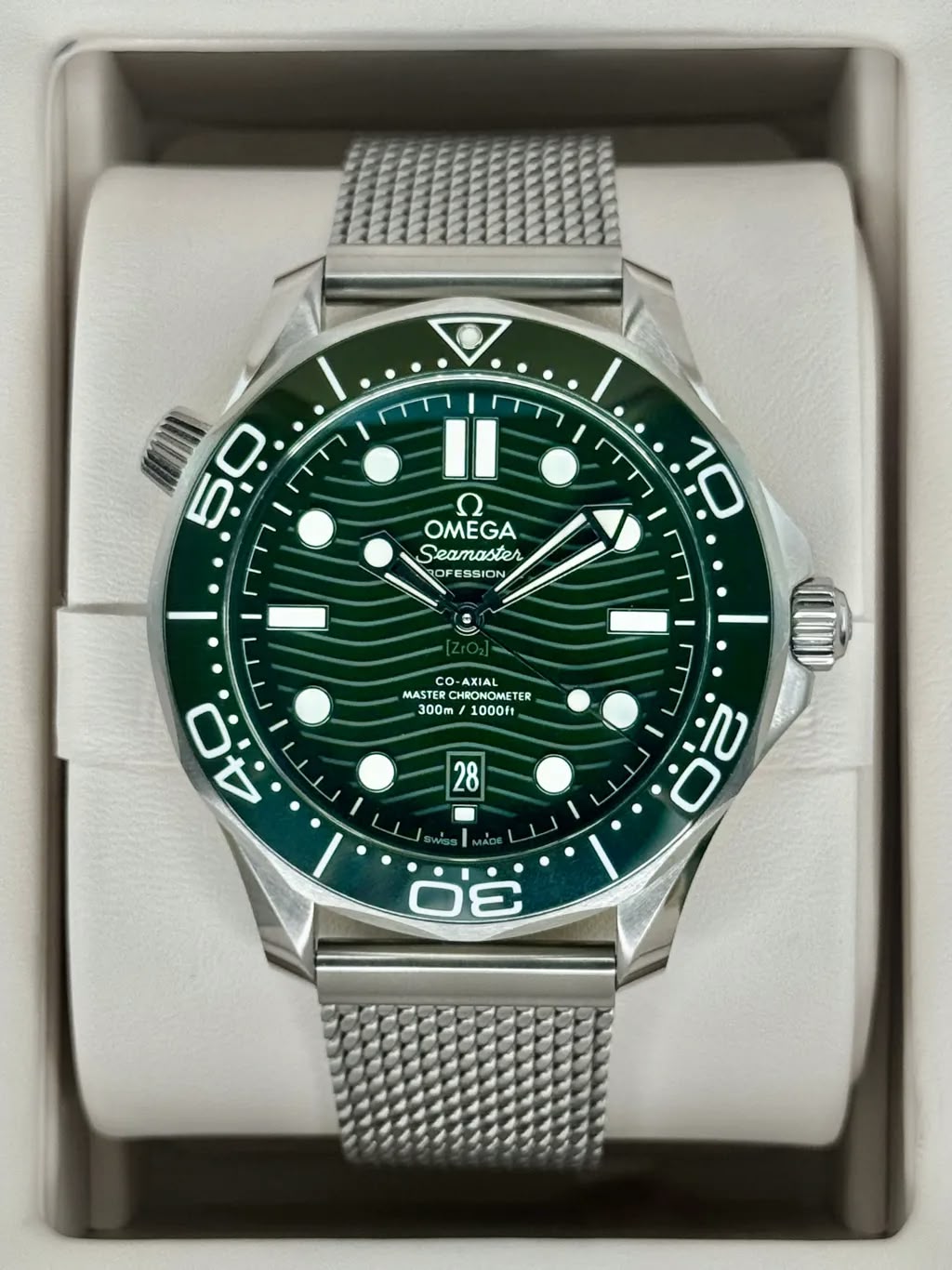 Omega Seamaster Diver 300M men's automatic watch, 42mm stainless steel case, green dial, mesh bracelet – dial view in box