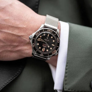 Omega Seamaster Diver men's automatic watch, 41mm stainless steel case, black dial, mesh bracelet – on wrist close-up