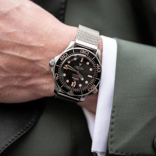 Omega Seamaster Diver men's automatic watch, 41mm stainless steel case, black dial, mesh bracelet – on wrist close-up