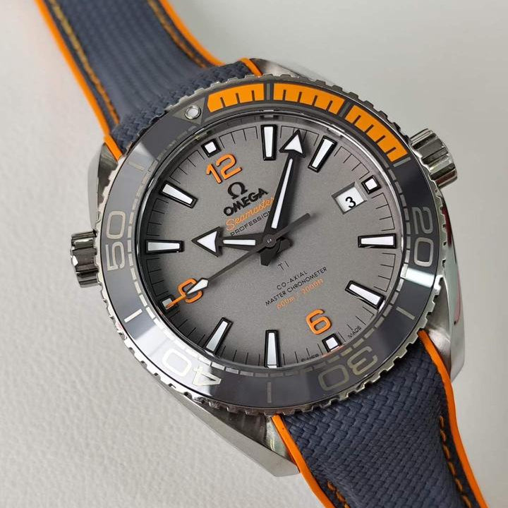 Omega Seamaster Planet Ocean 600M Titanium men's automatic watch, 43.5mm titanium case, grey dial, orange bezel, rubber strap – angle close-up