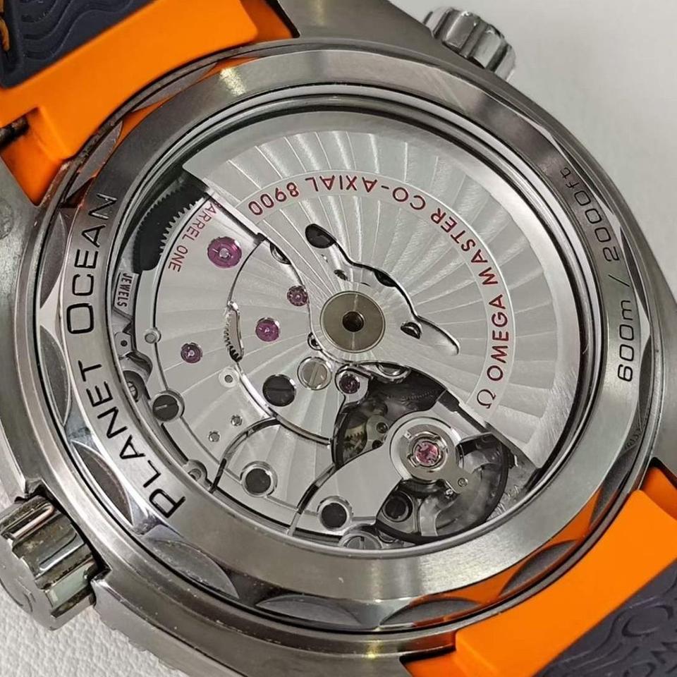 Omega Seamaster Planet Ocean 600M Titanium men's automatic watch, 43.5mm titanium case, grey dial, orange bezel, rubber strap – caseback movement view