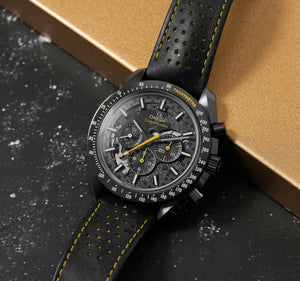 Omega Speedmaster Dark Side of the Moon Style men's chronograph watch, 45mm black case, black dial with yellow accents, black leather strap – angle view