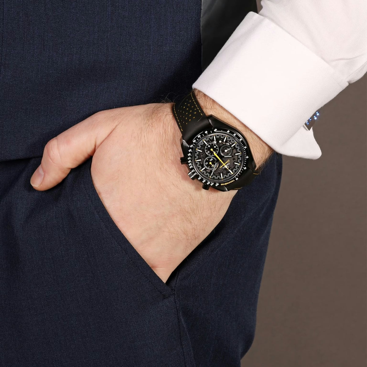 Omega Speedmaster Dark Side of the Moon Style men's chronograph watch, 45mm black case, black dial with yellow accents, black leather strap – lifestyle wrist view