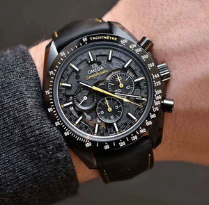 Omega Speedmaster Dark Side of the Moon Style men's chronograph watch, 45mm black case, black dial with yellow accents, black leather strap – on wrist view