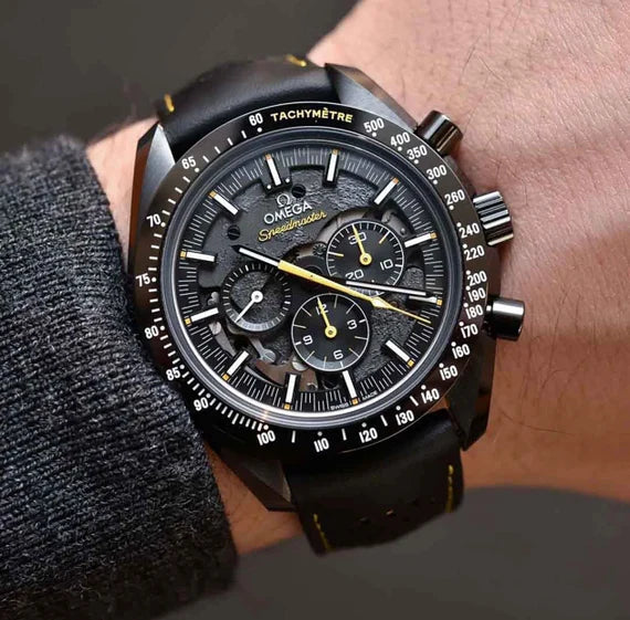 Omega Speedmaster Dark Side of the Moon Style men's chronograph watch, 45mm black case, black dial with yellow accents, black leather strap – on wrist view