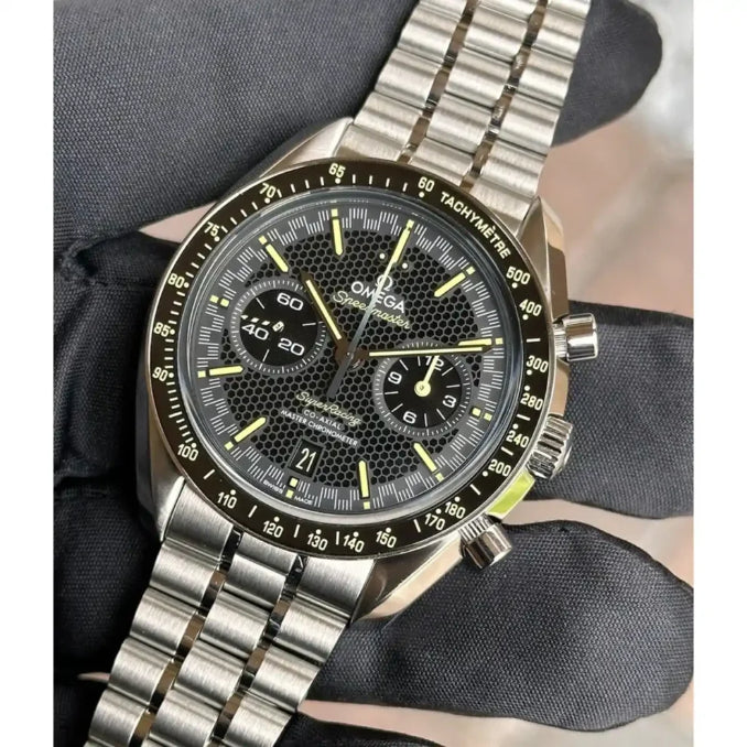 Omega Speedmaster Super Racing men's chronograph watch, 44.25mm stainless steel case, black dial, steel bracelet – hand-held angle view