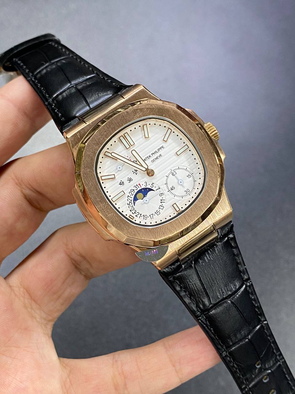 Patek Philippe Nautilus Moon Phase 40mm Men's Automatic Watch – White Dial, Rose Gold Case & Black Leather Strap | ساعة باتيك فيليب نوتيلس رجالي مينا أبيض