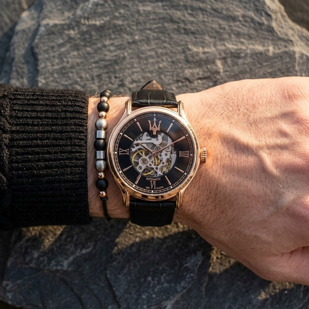 Close up of Maserati Epoca R8821118001 automatic watch on wrist showing black skeleton dial and mechanical gears