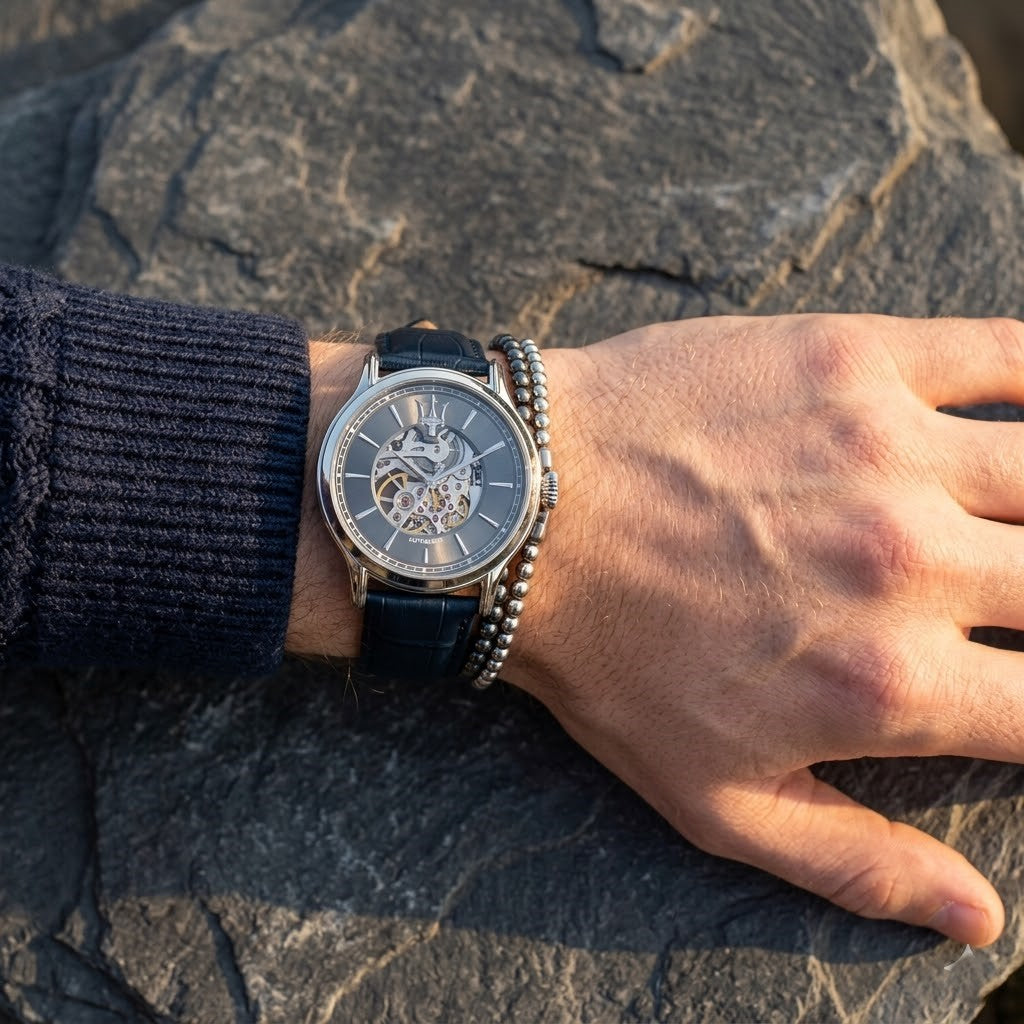 Close up of Maserati Epoca R8821118002 automatic watch on wrist showing gray skeleton dial and mechanical gears