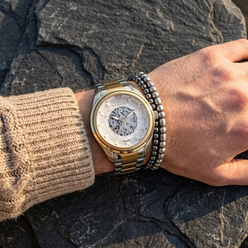 Close up of Maserati Traguardo R8823112003 automatic watch on wrist showing white open heart dial and gold-tone details