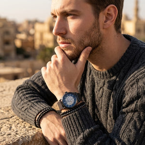 Elegant man wearing Maserati Epoca R8823118006 automatic watch with gunmetal case and luxury blue open heart dial
