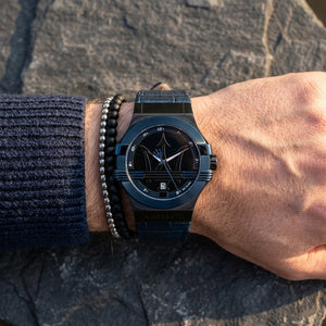 Close up of Maserati Potenza R8851108007 men's quartz battery watch on wrist showing black dial and blue-tone case