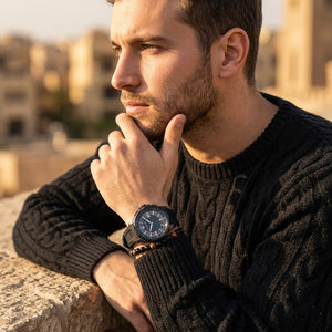 Elegant man wearing Maserati Sfida R8851123004 men's quartz battery watch with black case and luxury racing carbon dial
