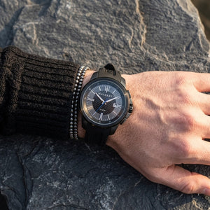 Close up of Maserati Sfida R8851123004 men's quartz battery watch on wrist showing black carbon fiber racing dial and blue hand