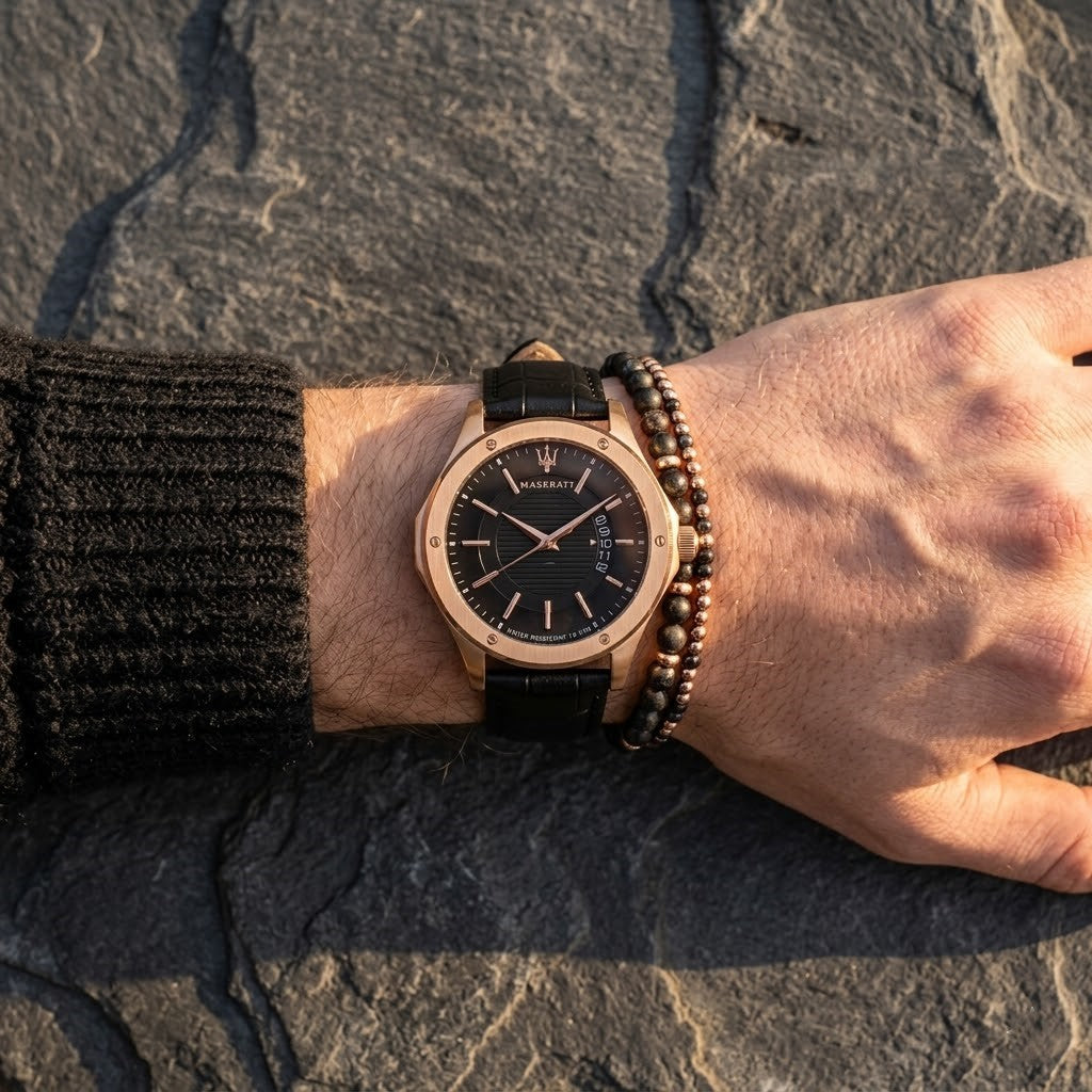 Close up of Maserati Circuito R8851127001 men's quartz battery watch on wrist showing black textured dial and rose gold-tone case