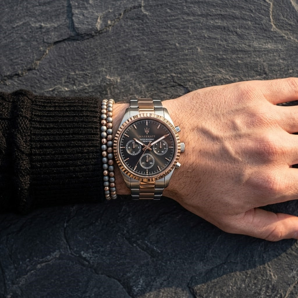 Close up of Maserati Competizione R8853100020 men's quartz battery watch on wrist showing black sunray dial and two-tone metal bracelet