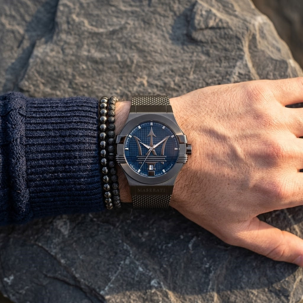 Close up of Maserati Potenza R8853108005 men's quartz battery watch on wrist showing blue textured dial and grey mesh metal strap