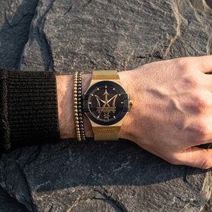 Close up of Maserati Potenza R8853108006 men's quartz battery watch on wrist showing black textured dial and gold mesh metal strap