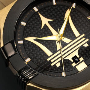 Black and gold watch with a unique design on the dial