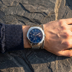 Close up of Maserati Traguardo R8853112505 men's quartz battery watch on wrist showing blue multi-function dial and silver case