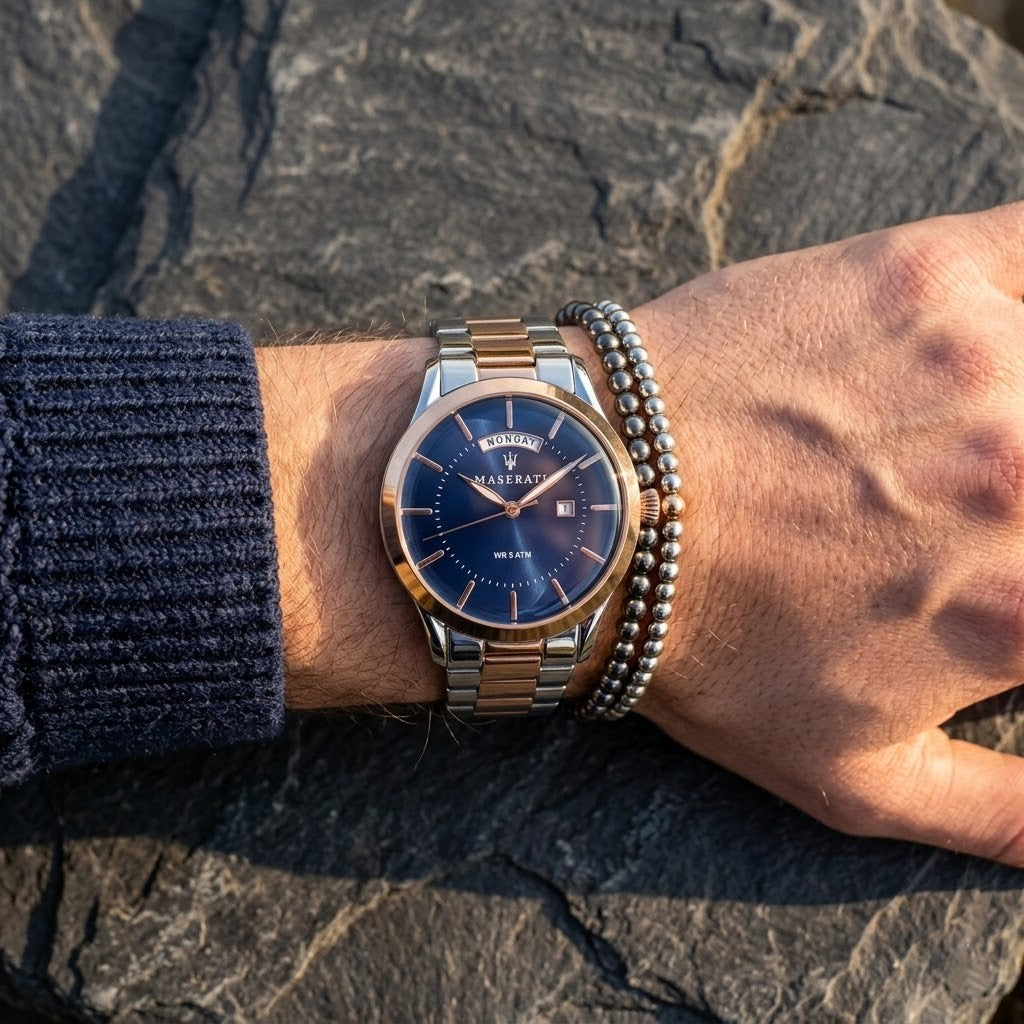 Close up of Maserati Tradizione R8853125001 men's quartz battery watch on wrist showing blue dial and two-tone metal bracelet