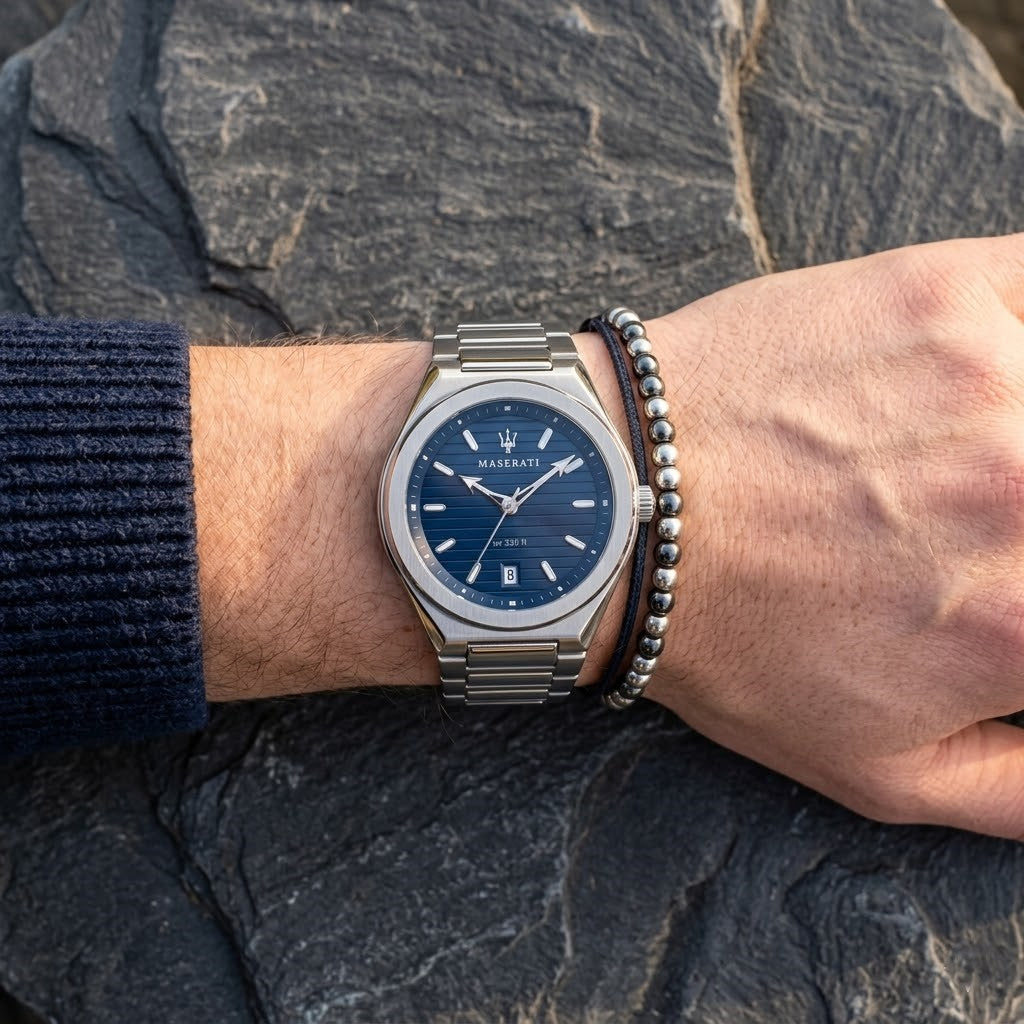 Close up of Maserati Triconic R8853139002 men's quartz battery watch on wrist showing blue striped dial and silver-tone hands