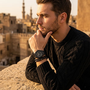 Elegant man wearing Maserati Triconic R8853139004 men's quartz battery watch with black case and luxury gold accented dial