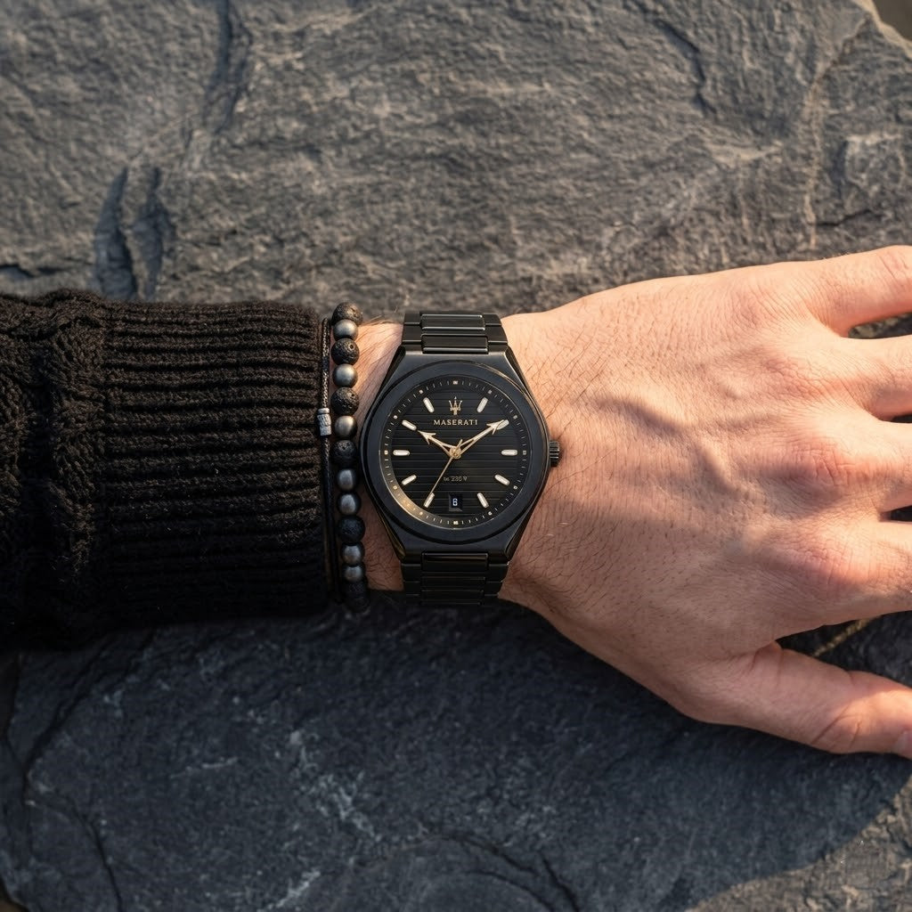Close up of Maserati Triconic R8853139004 men's quartz battery watch on wrist showing black striped dial and gold-tone hands