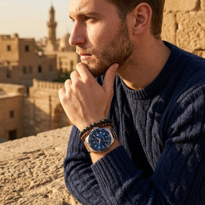 Elegant man wearing Maserati Sfida R8853140003 men's quartz battery watch with two-tone rose gold case and luxury blue dial