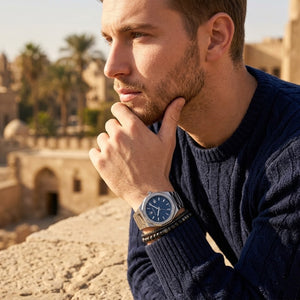 Elegant man wearing Maserati Stile R8853142006 men's quartz battery watch with silver case and luxury blue dial