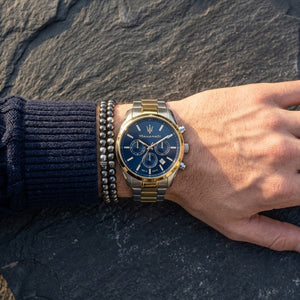 Close up of Maserati Attrazione R8853151008 men's quartz battery watch on wrist showing blue sunray dial and two-tone metal bracelet