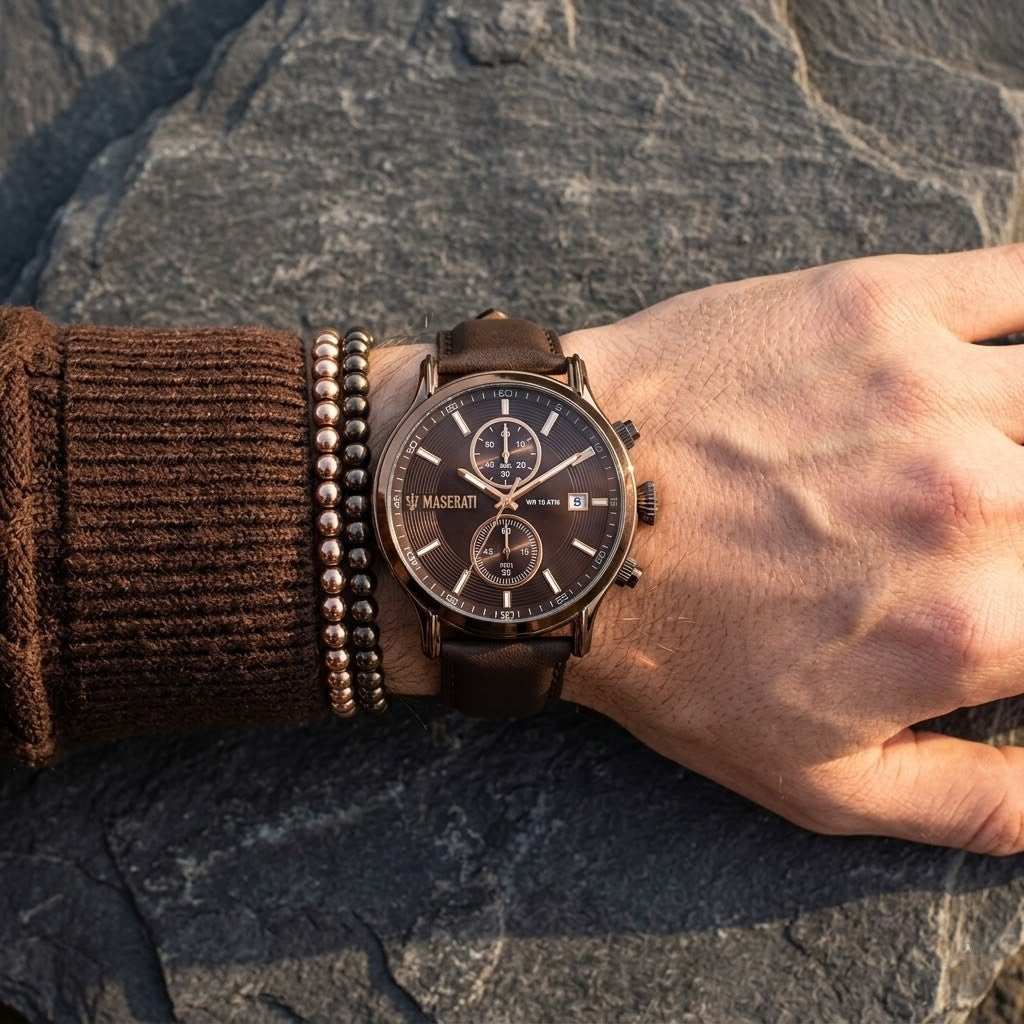 Close up of Maserati Epoca R8871618006 men's quartz battery watch on wrist showing brown sunray dial and bronze-tone case