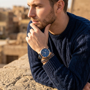Elegant man wearing Maserati Epoca R8871618007 men's quartz battery watch with rose gold case and luxury blue dial