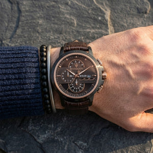 Close up of Maserati Ingegno R8871619001 men's quartz battery watch on wrist showing technical brown dial and brown leather strap
