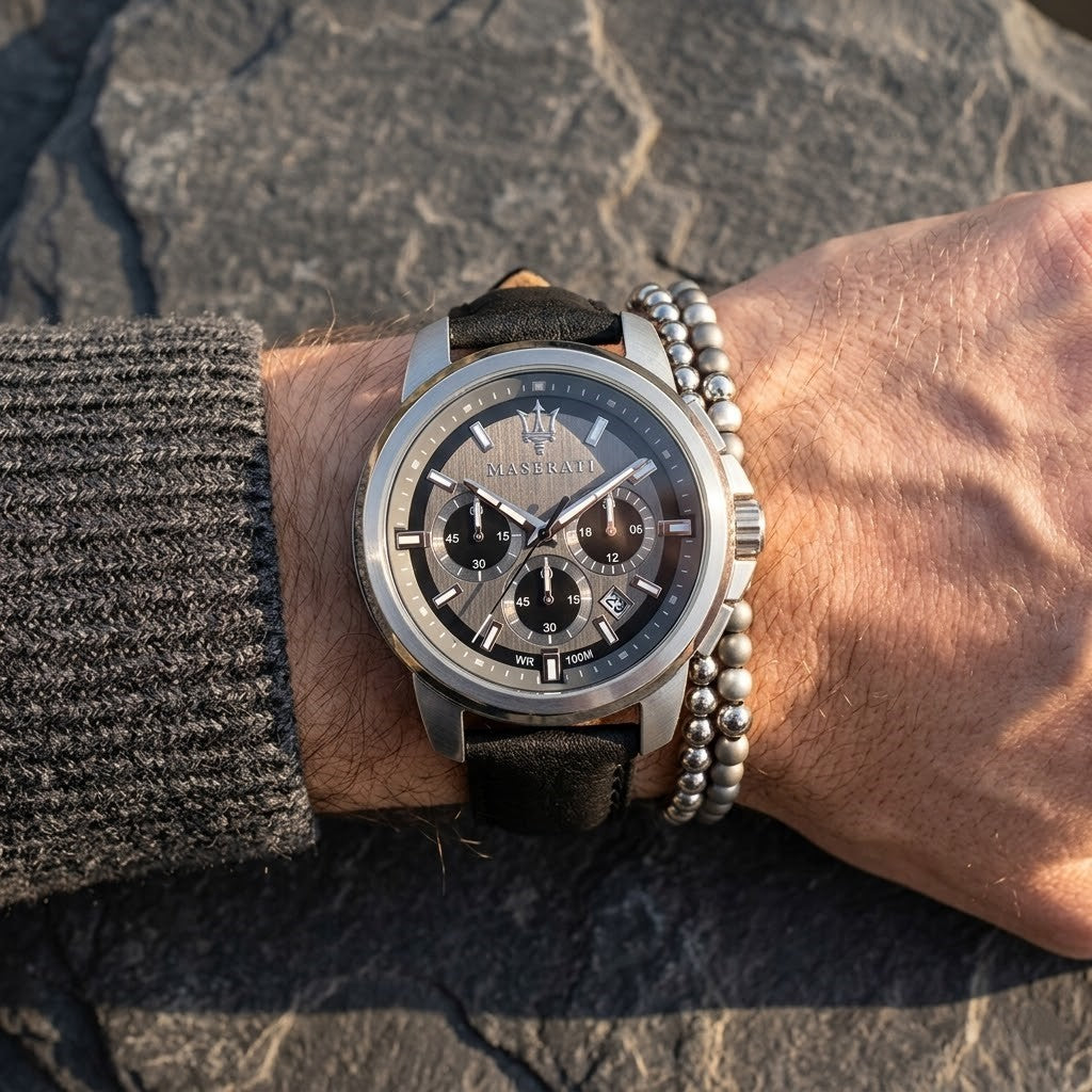Close up of Maserati Successo R8871621006 men's quartz battery watch on wrist showing gray sunray dial and black leather strap