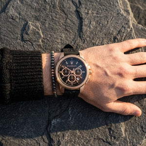 Close up of Maserati Successo R8871621012 men's quartz battery watch on wrist showing black racing dial and rose gold-tone case