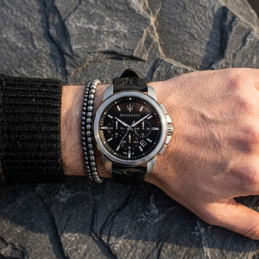 Close up of Maserati Successo R8871621014 men's quartz battery watch on wrist showing black sunray dial and black rubber strap