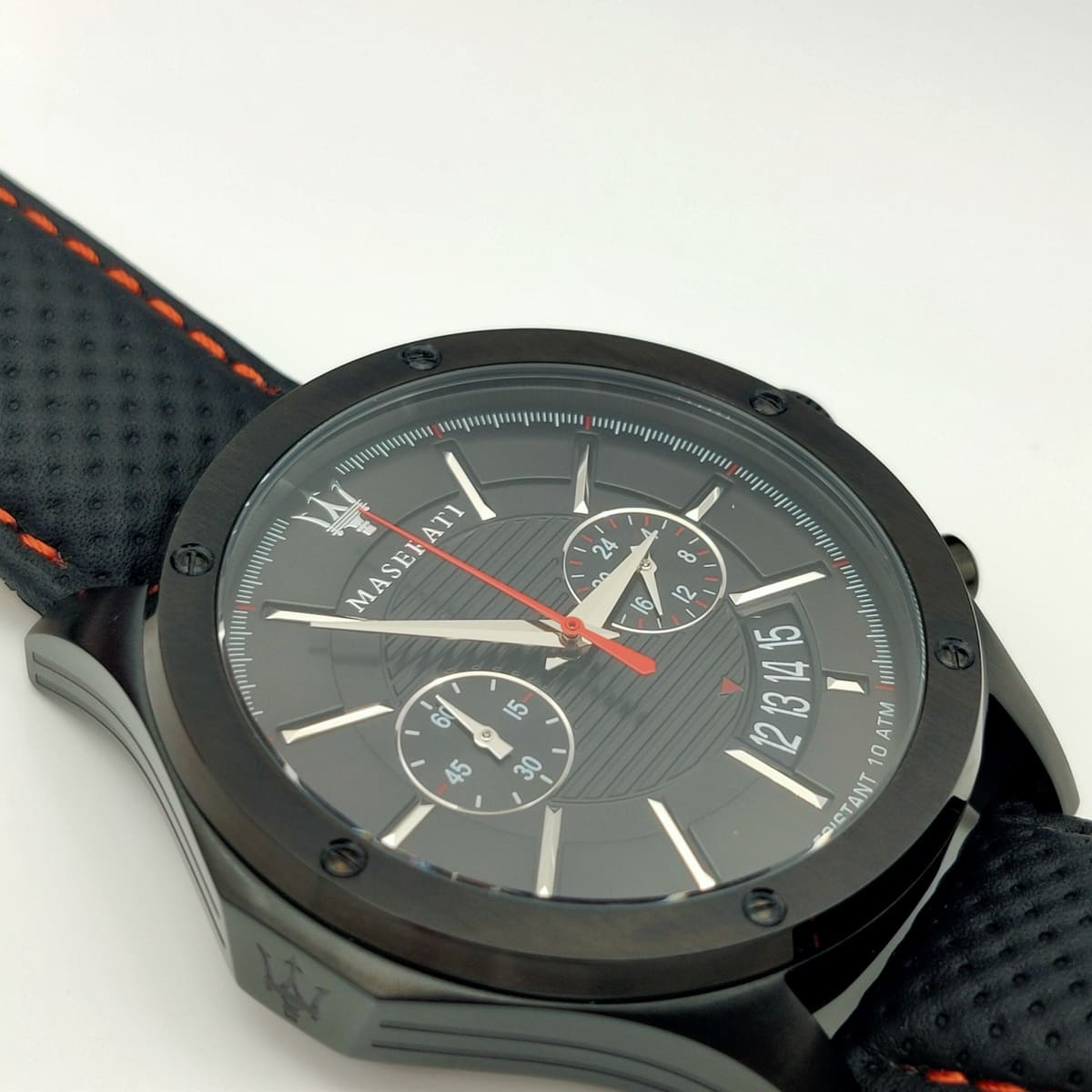 Black wristwatch with detailed face on a white background