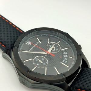 Black wristwatch with detailed face on a white background