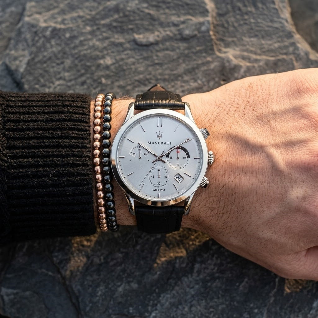 Close up of Maserati Ricordo R8871633001 men's quartz battery watch on wrist showing silver sunray dial and black leather strap