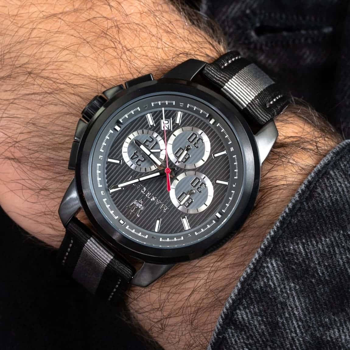 Elegant man wearing Maserati Royale R8871637002 men's quartz battery watch with black case and luxury racing dial