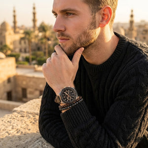 Elegant man wearing Maserati Stile Chronograph R8871642001 men's quartz battery watch with rose gold case and luxury black leather strap
