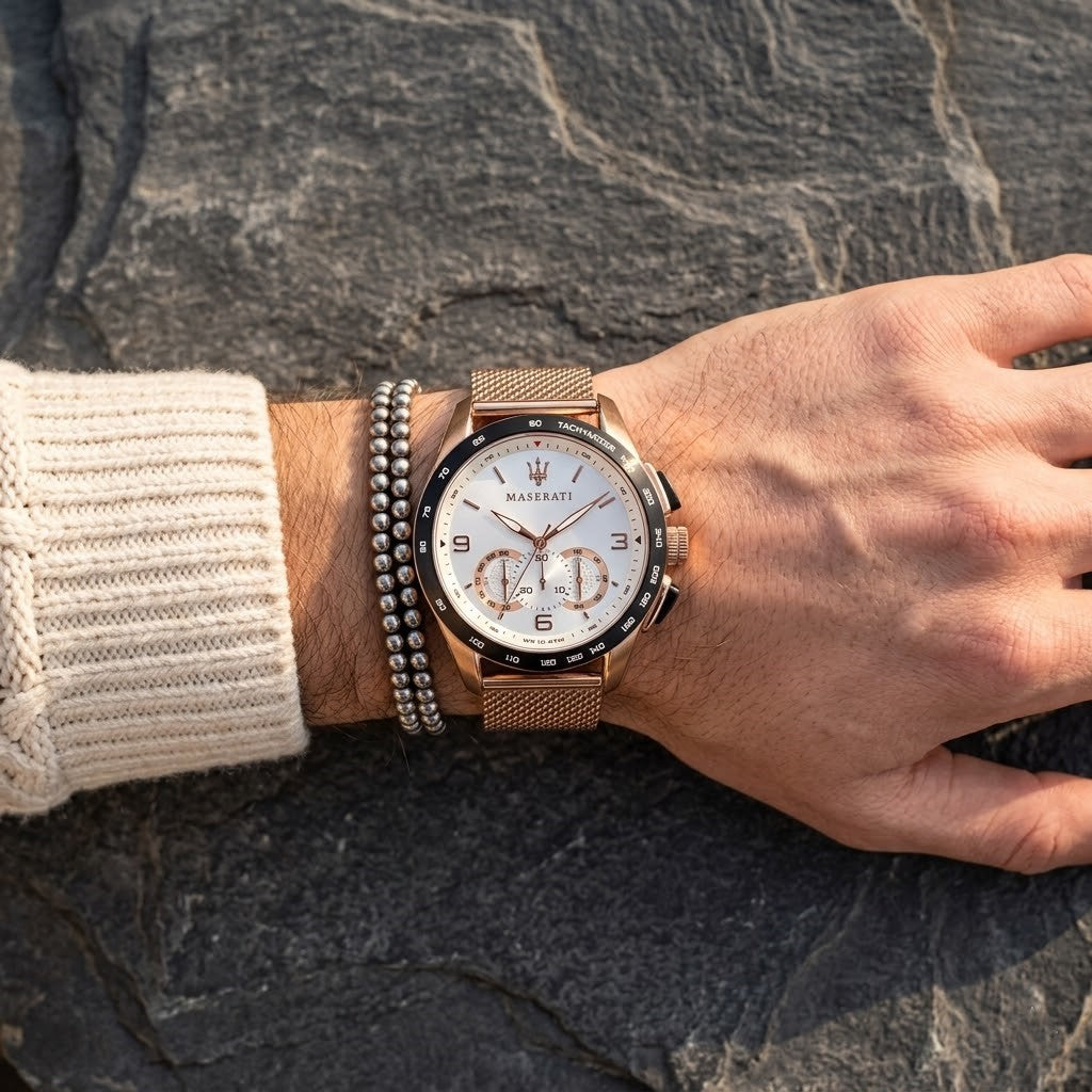 Close up of Maserati Traguardo R8873612011 men's quartz battery watch on wrist showing white racing dial and rose gold mesh strap