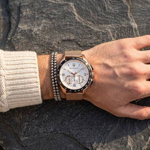 Close up of Maserati Traguardo R8873612011 men's quartz battery watch on wrist showing white racing dial and rose gold mesh strap