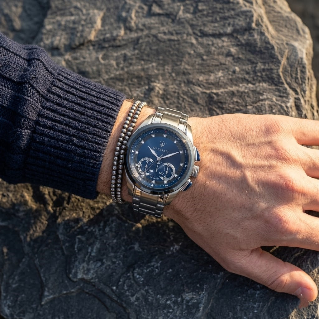 Close up of Maserati Traguardo R8873612014 men's quartz battery watch on wrist showing blue sunray dial and silver metal bracelet