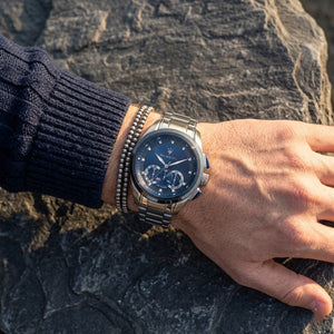 Close up of Maserati Traguardo R8873612014 men's quartz battery watch on wrist showing blue sunray dial and silver metal bracelet