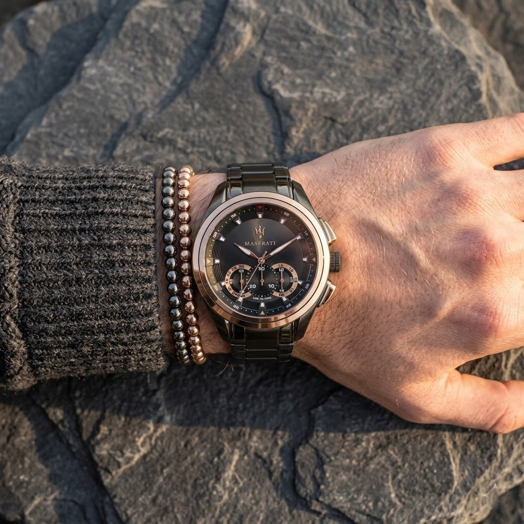 Close up of Maserati Traguardo R8873612016 men's quartz battery watch on wrist showing black chronograph dial and gunmetal grey metal bracelet