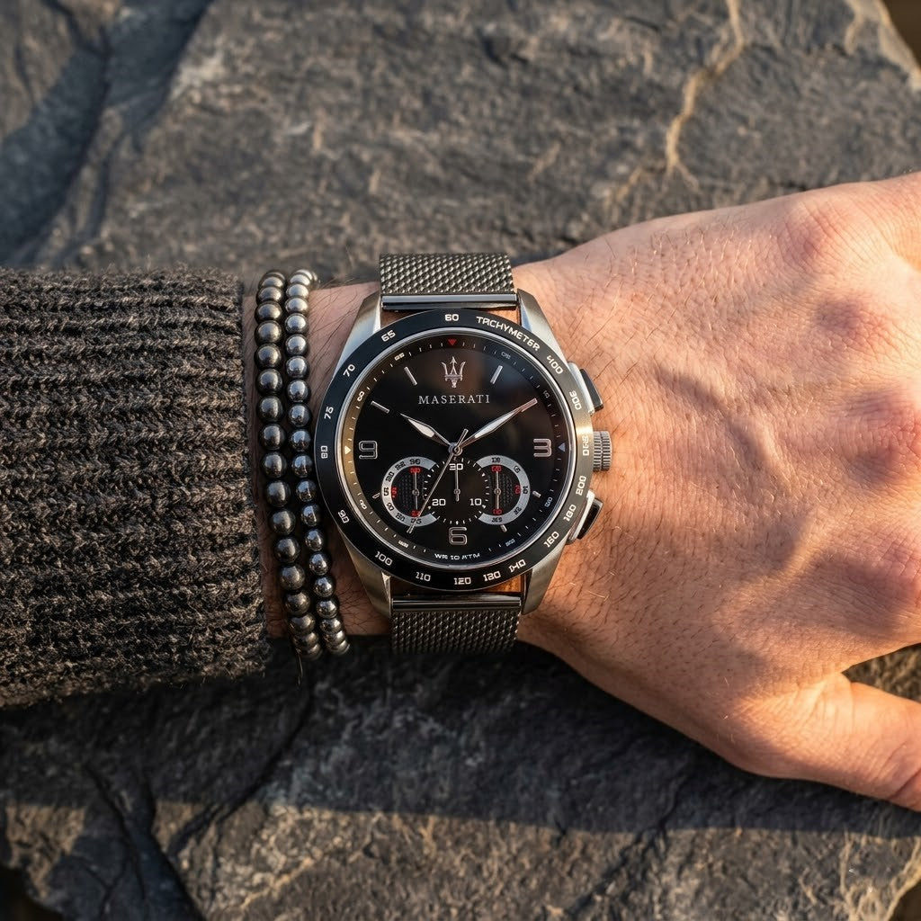 Close up of Maserati Traguardo R8873612031 men's quartz battery watch on wrist showing black sunray dial and black mesh metal strap