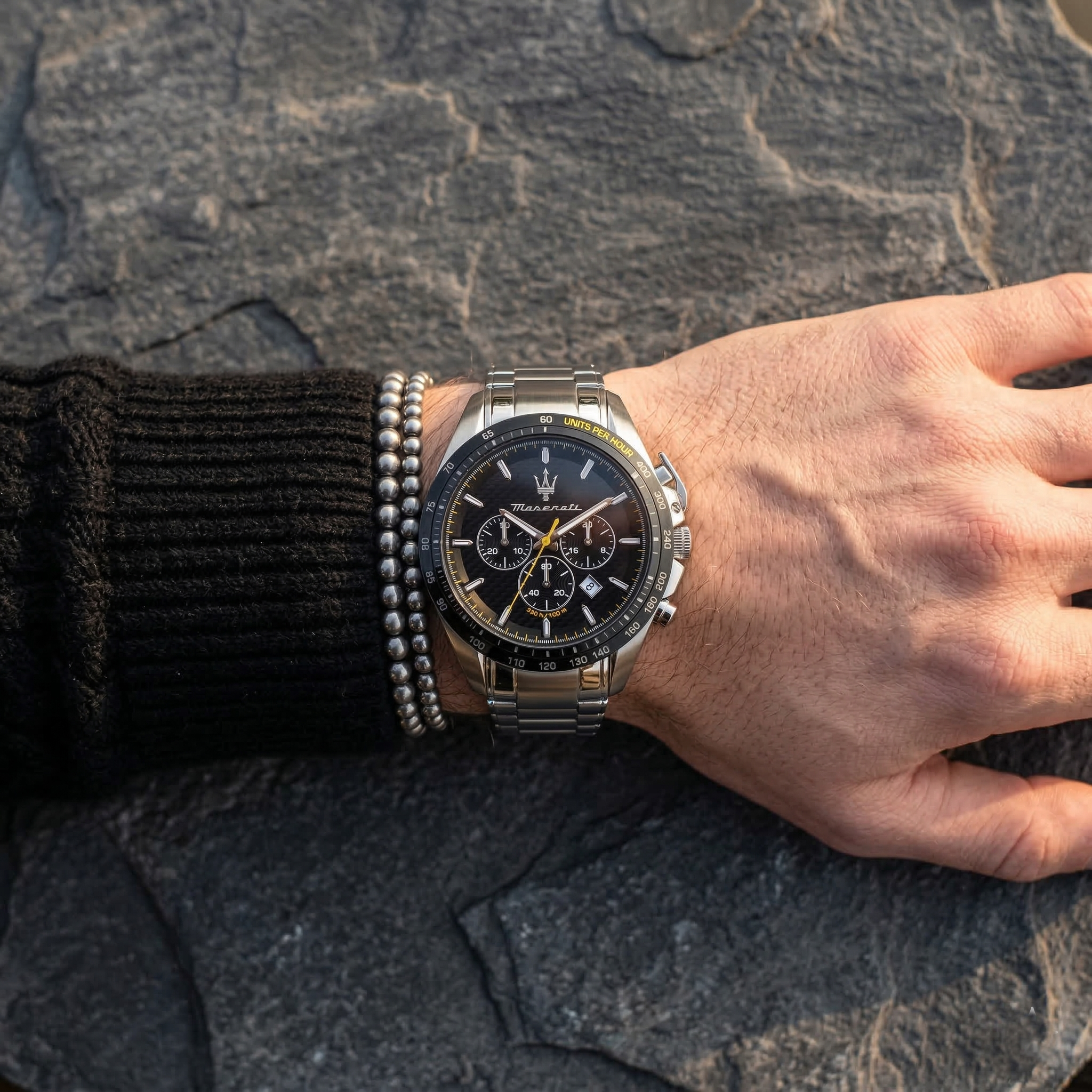 Close up of Maserati Traguardo R8873612042 men's quartz battery watch on wrist showing black chronograph dial and silver metal bracelet