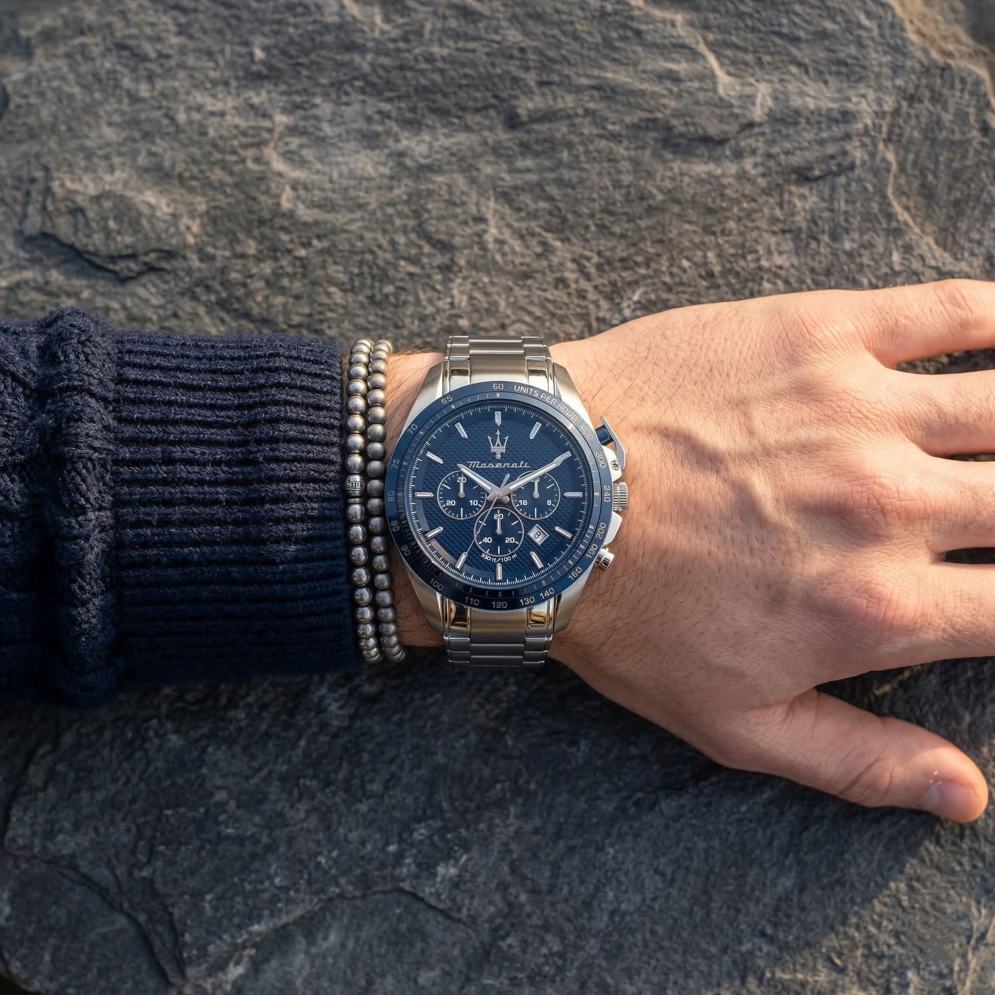 Close up of Maserati Traguardo R8873612043 men's quartz battery watch on wrist showing blue chronograph dial and silver metal bracelet